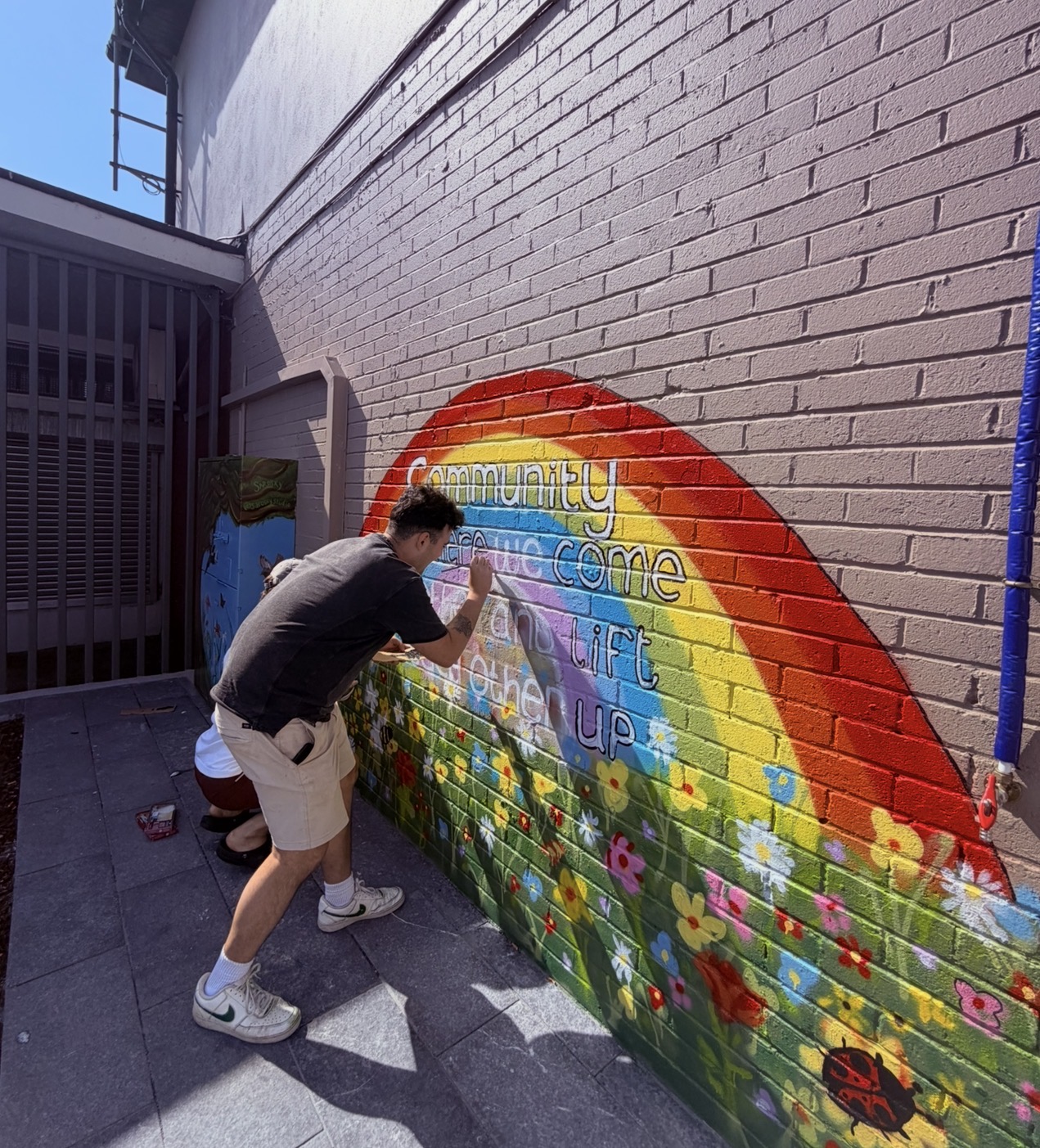 Barry painting a community mural